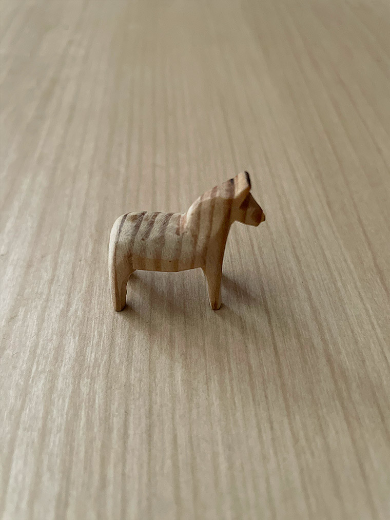 Small tiny carved wood Dala horse from Sweden with vertical grain